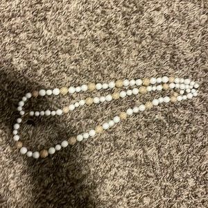 White necklaces with gold on it